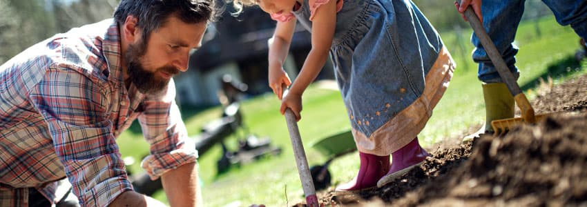 Dad and Kids Planting Tree